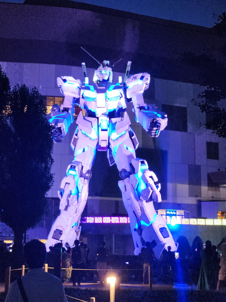 A large Gundam statue lit up